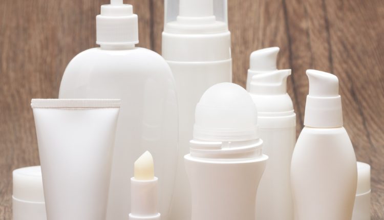 Daily skincare cosmetics on wooden surface