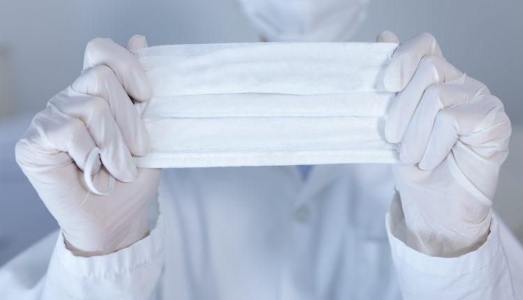 Healthcare worker wearing protective suit and face mask during coronavirus Covid19 pandemic
